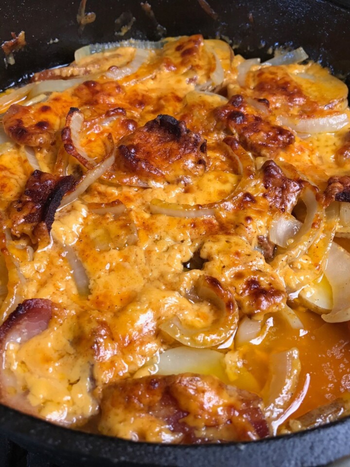 Top view of cheesy potatoes in a dutch oven.