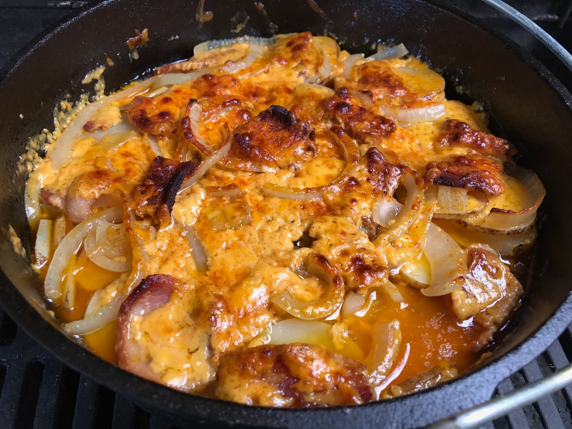 Top view of cheesy potatoes in a dutch oven.