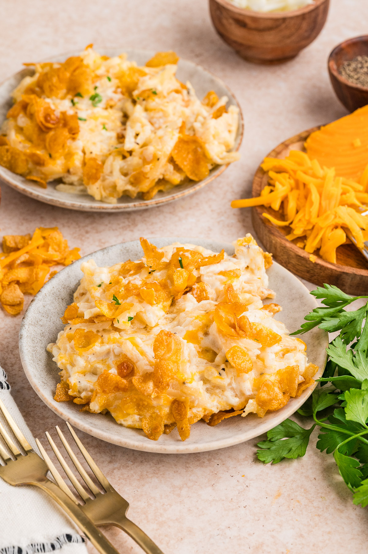 Dutch oven funeral potatoes served on plates on a table.