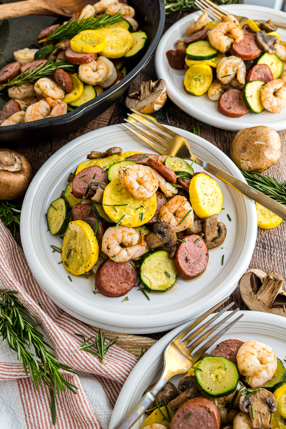 Cast iron shrimp and sausage skillet on a plate with a fork.