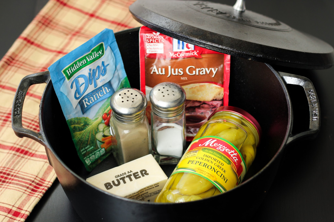 Au jus mix, Ranch mix, butter, pepperoncinis, salt and pepper inside a Dutch oven. 