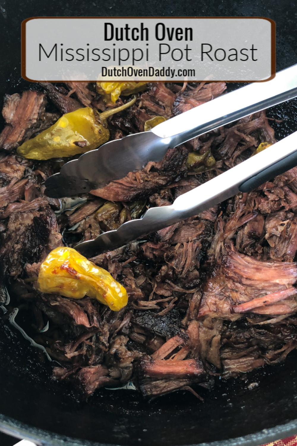 A close of the cooked Mississippi Pot Roast in the Dutch oven with tongs. 