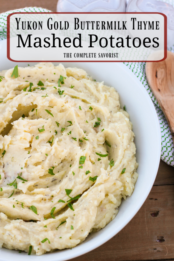 A bowl of Yukon gold buttermilk mashed potatoes with thyme from the website The Complete Savorist.