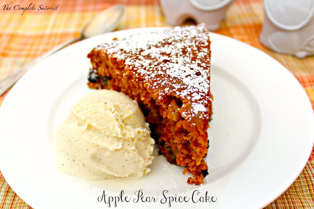 Slice of skillet apple pear spice cake with a scoop of vanilla bean ice cream.