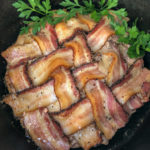 Cooked Dutch oven peppered bacon meatloaf garnished with fresh parsley