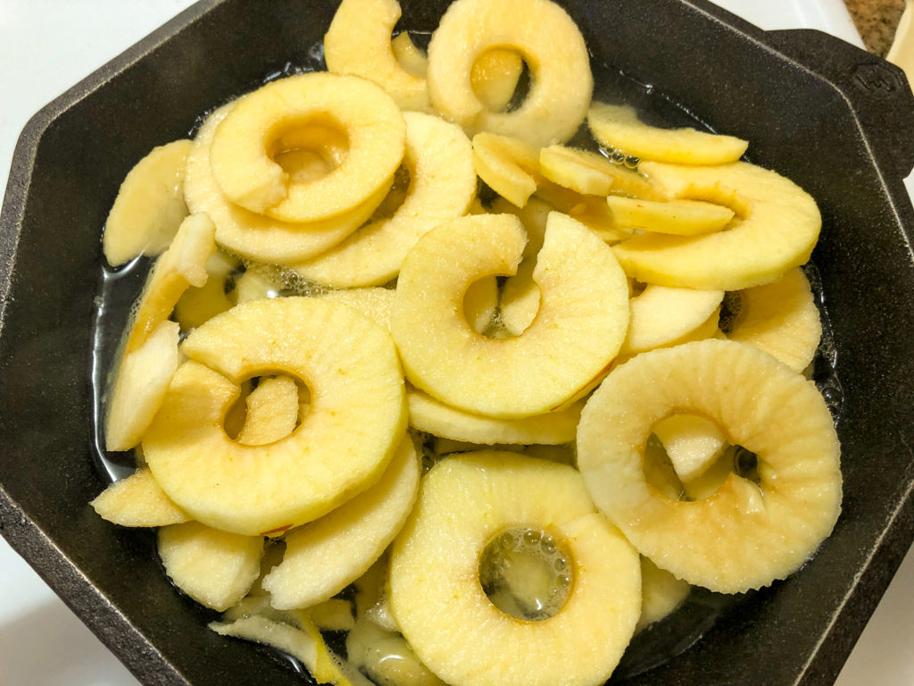 Fresh apples being boiled down in a cast iron skillet