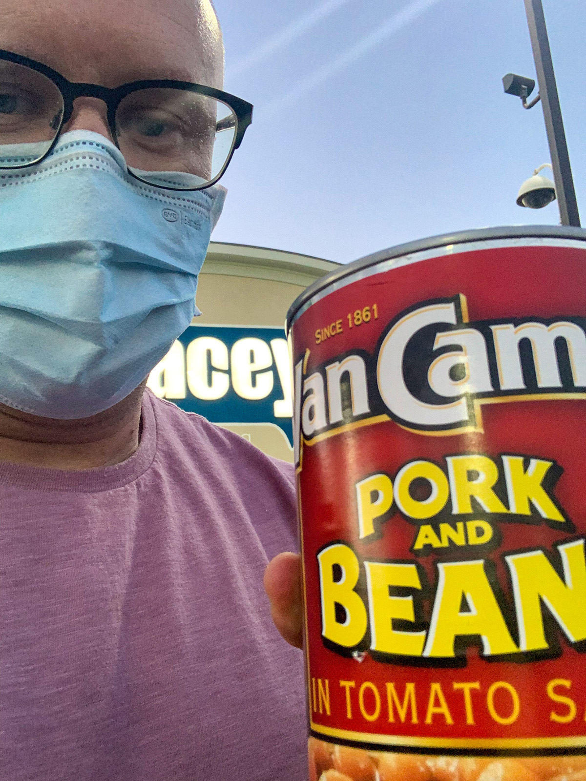 Dutch Oven Daddy wearing a mask holding a can of Van Camp's pork and beans