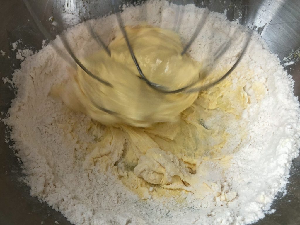 Flour, almond extract, salt, and heavy cream have been added to the sugared egg yolk mixture.