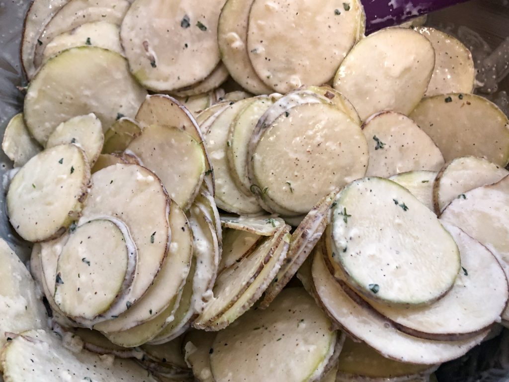 Sliced potatoes with the cream sauce mixed in. 
