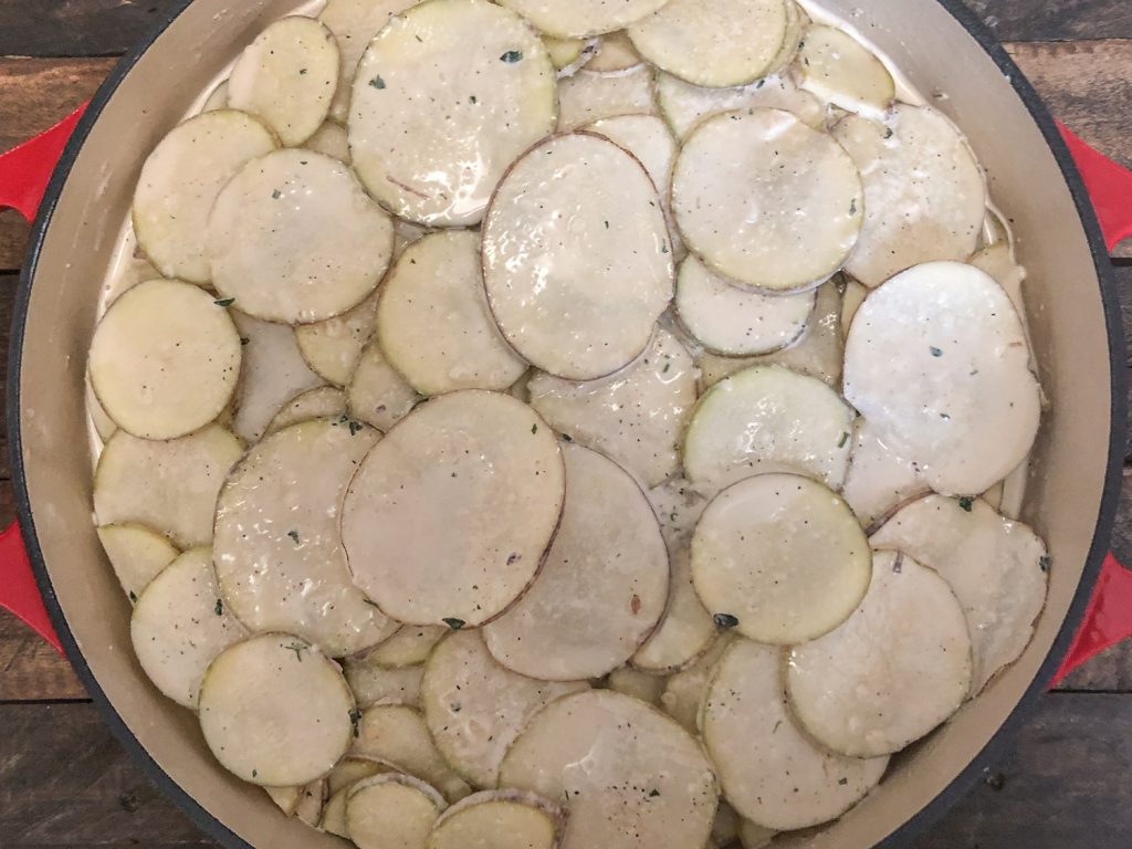 Potatoes layered in the skillet.