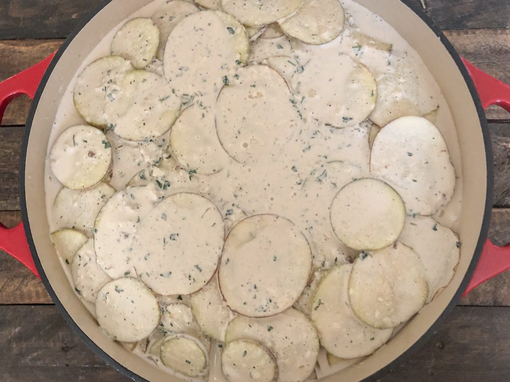Remaining cream sauce has been poured over the layered potatoes.