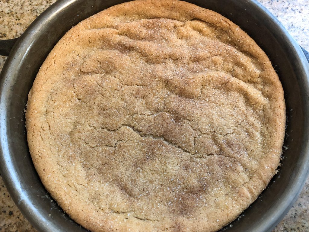 Freshly baked snickerdoodle cookie cooling in the cast iron skillet.