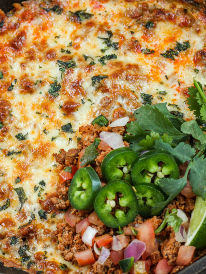 Close up of cooked and garnished dip.