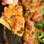 Chorizo Cheese Dip on a Tortilla chip.