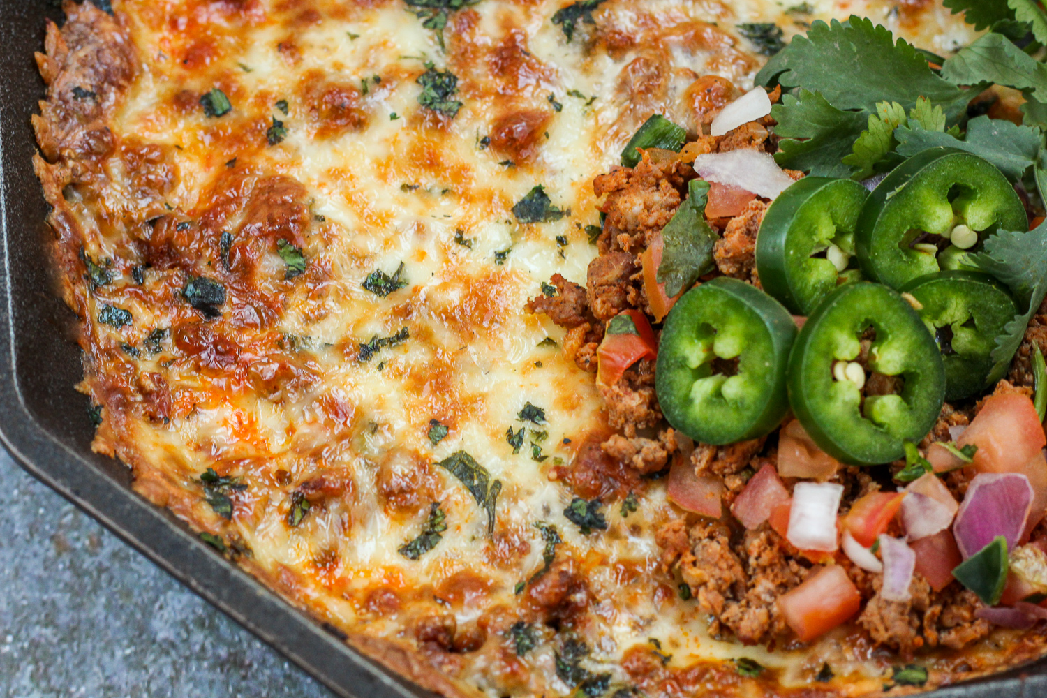 Close up of cooked and garnished dip.