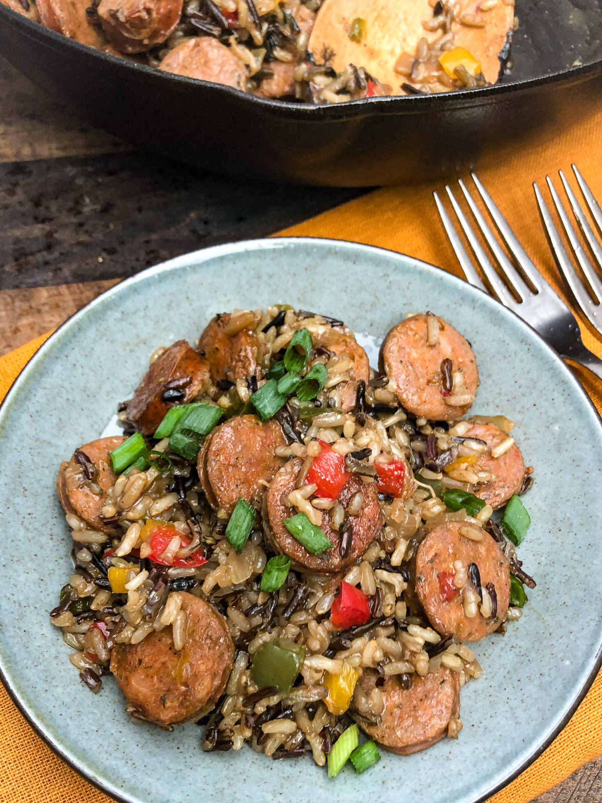 Branded image of the plated rice and sausage dish.