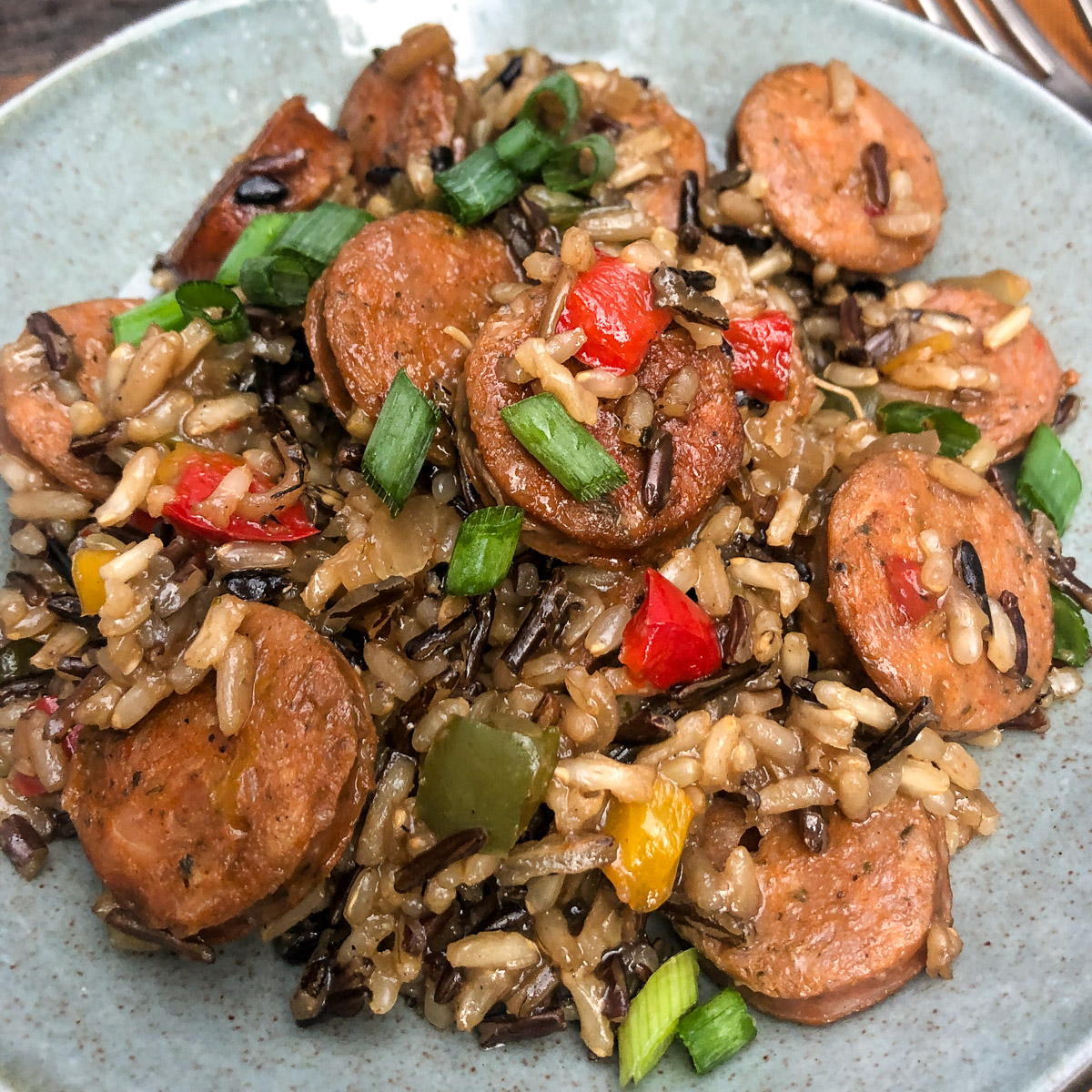 Sausage Onions and Peppers ready to eat on a plate.