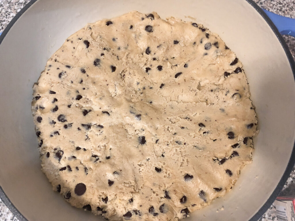 Pillsbury cookie dough in an enameled cast iron skillet.