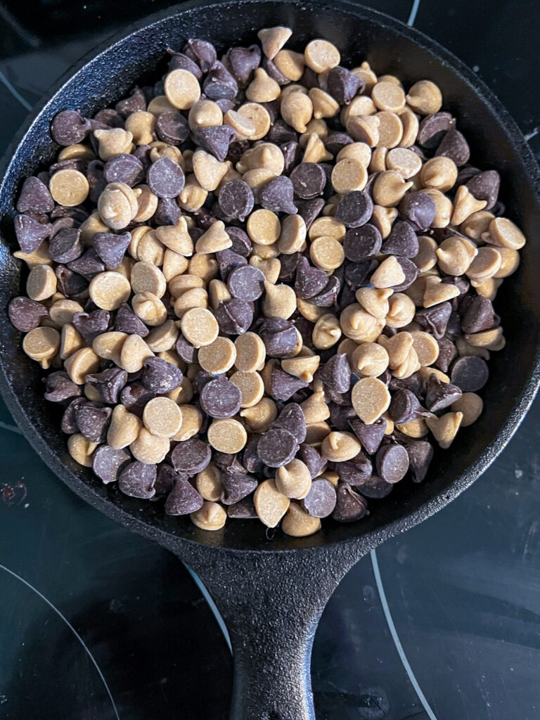 Chocolate and peanut butter ships mixed and put in a cast iron skillet.