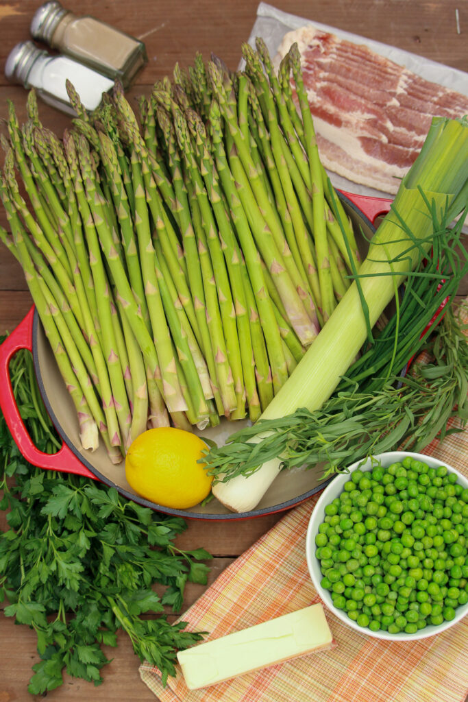 Recipe ingredients: fresh parsley, lemon, fresh asparagus, salt, pepper, bacon, fresh leeks, fresh chives, fresh tarragon, frozen peas, and salted butter.