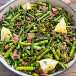 Bacon, peas, leeks, asparagus, fresh herbs, and fresh lemon in a Dutch oven.