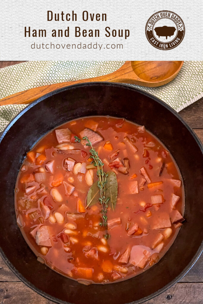 Branded image of tomato-based Dutch Oven Ham and Bean Soup garnished with bay leaves and fresh thyme.