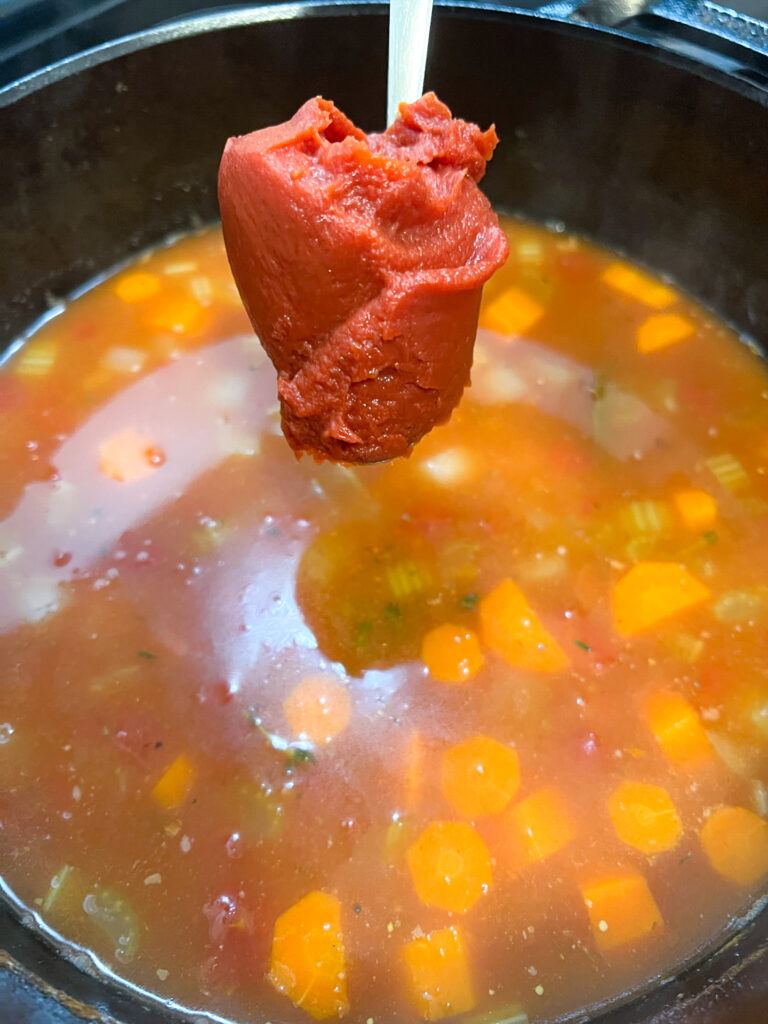 Tomato paste being added to the soup as a thickener. 