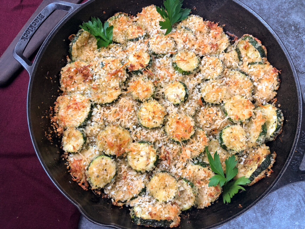 Skillet of freshly baked Parmesan Zucchini Chips ready to serve.