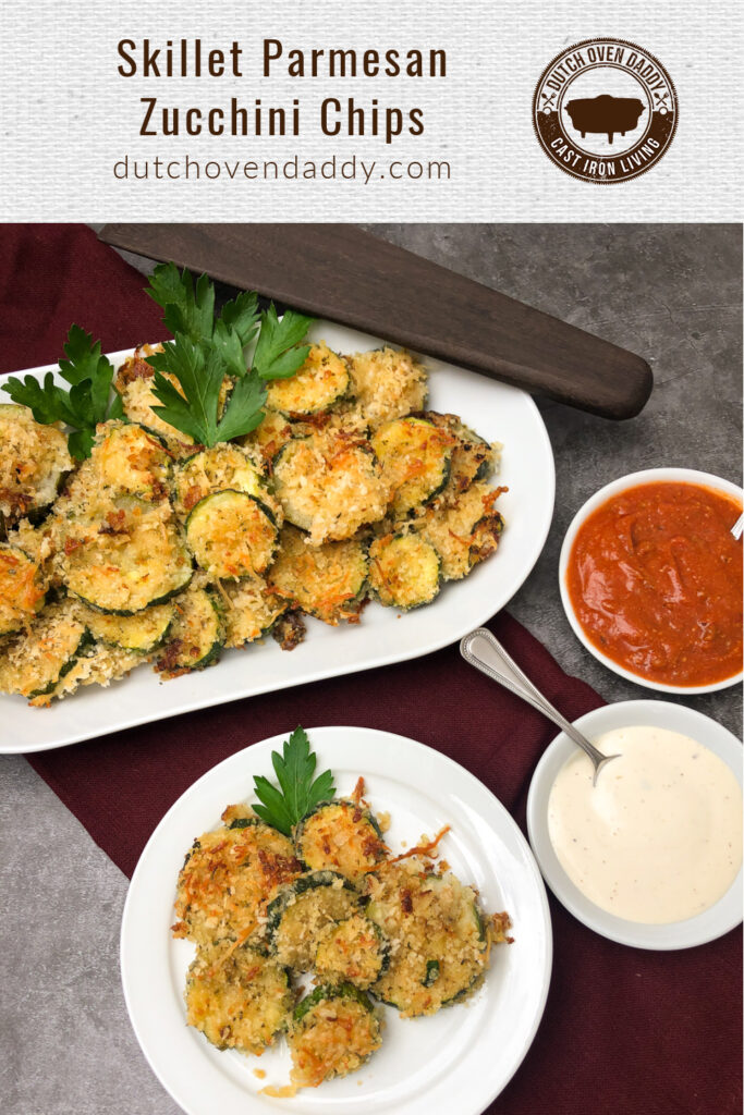 Branded image of Parmesan Zucchini Chips on a platter in the back, a portion on a white plate with ranch dressing and marinara sauce in bowls on the side.