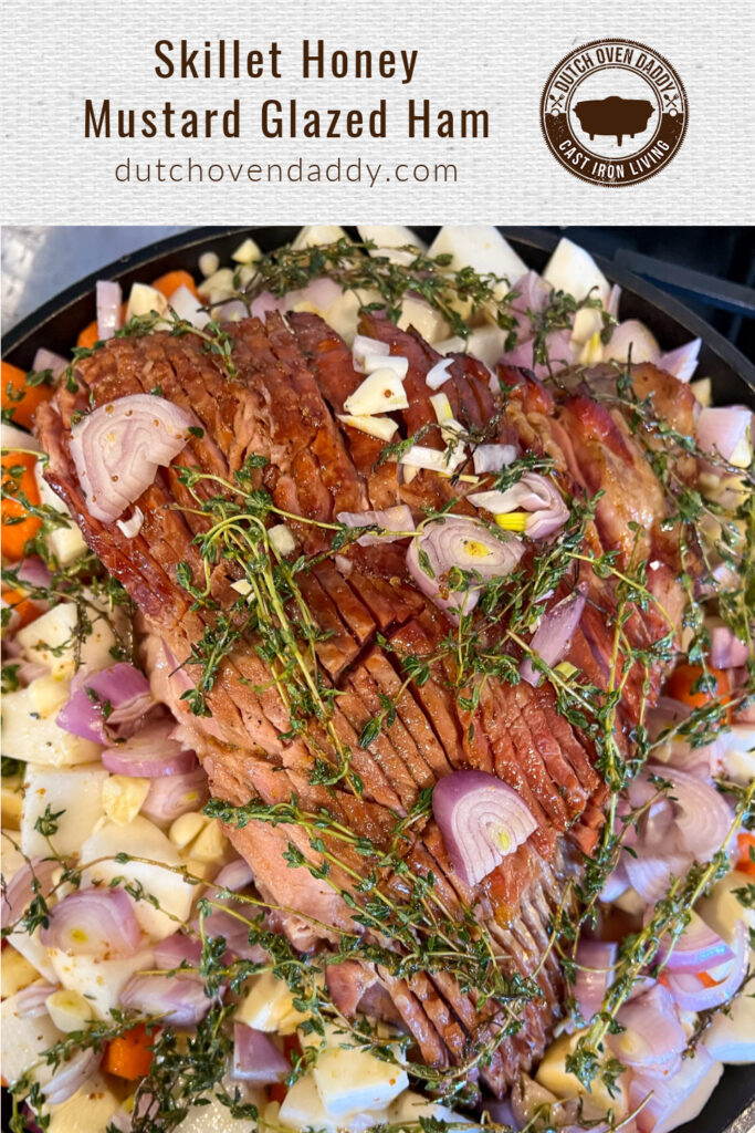 Branded image of the ham topped with fresh shallots, garlic, and thyme surrounded by parsnips, turnips, and carrots drenched in a honey mustard glaze. 