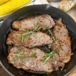 Cast iron steaks in a cast iron skillet.
