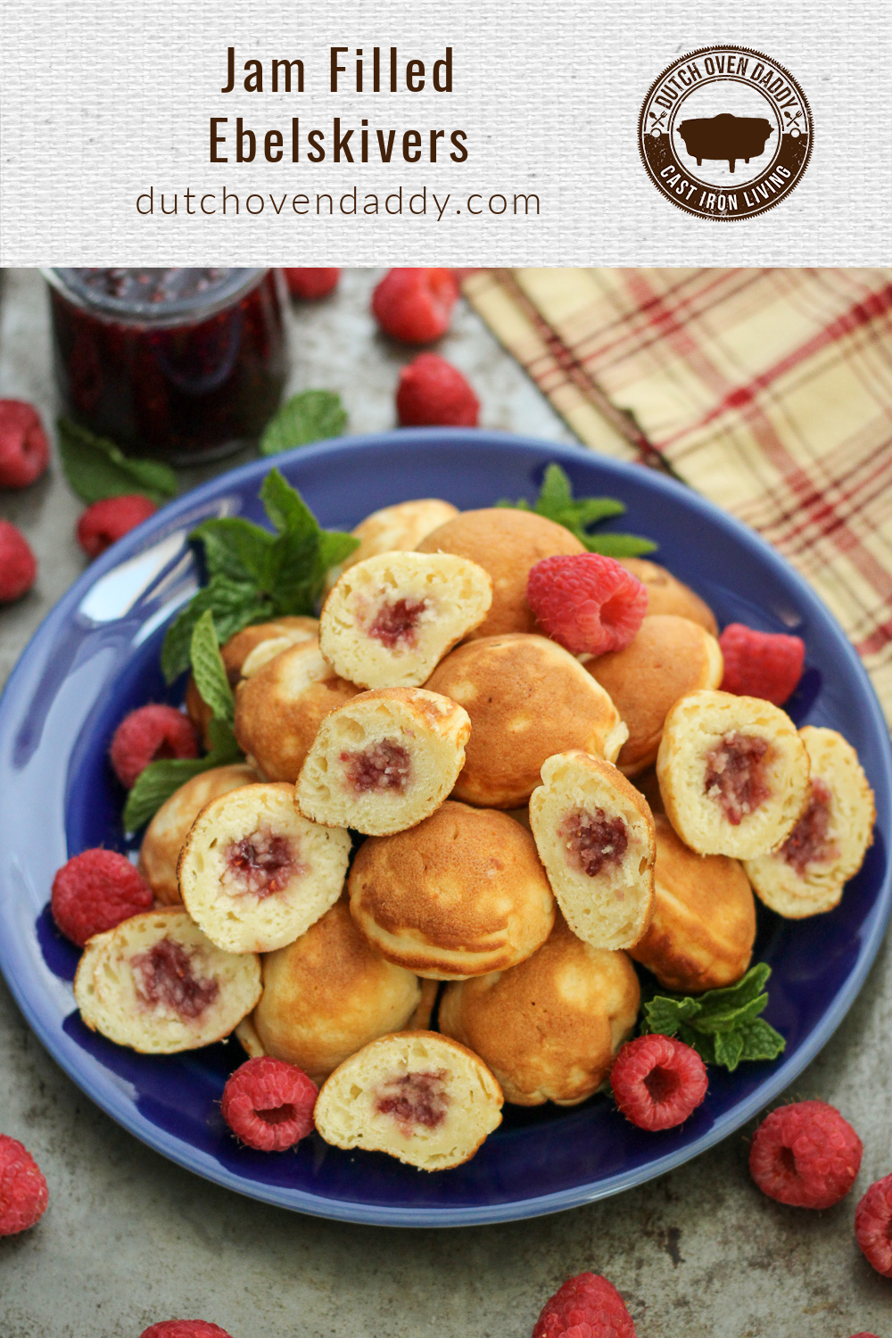 Branded image of Jam Filled Ebelskivers or aebleskivers on a blue plate garnished with fresh raspberries and mint.