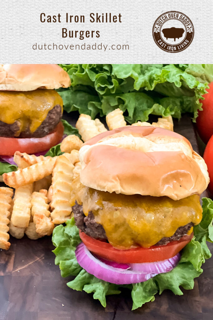 Branded image of Cast Iron Skillet burgers in a bun with lettuce, onion and tomato; fries plated as well.