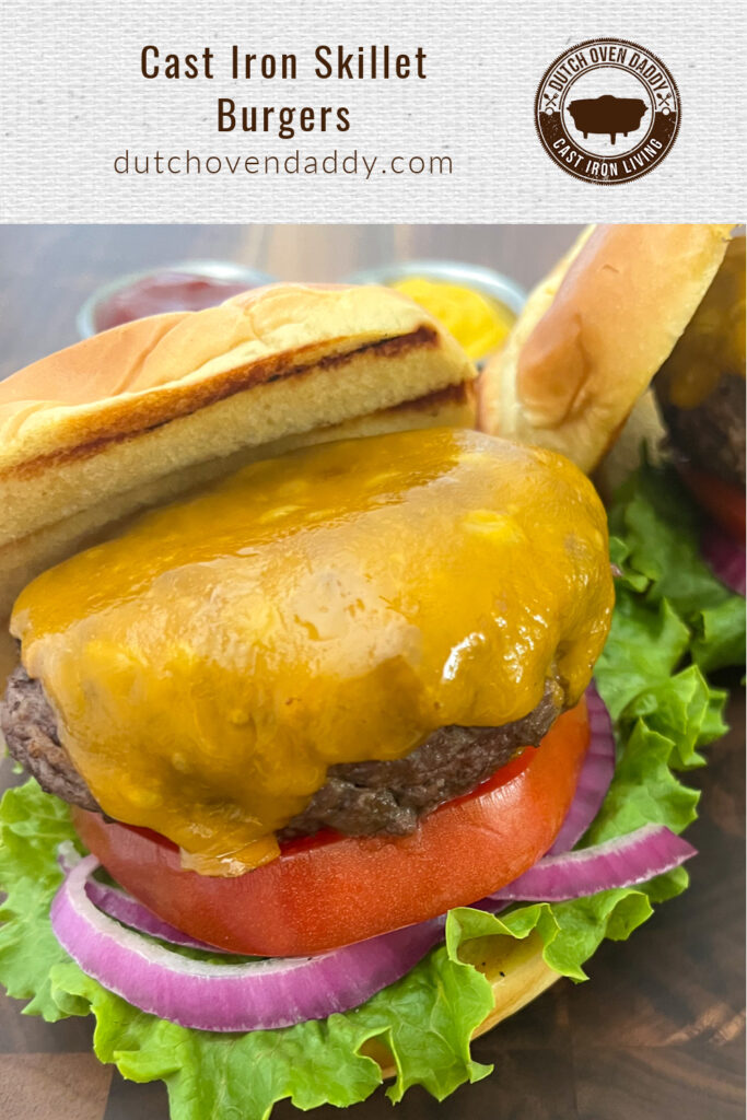 Branded image of cast iron skillet burgers with melted cheese and the top bun askew to show the patty.