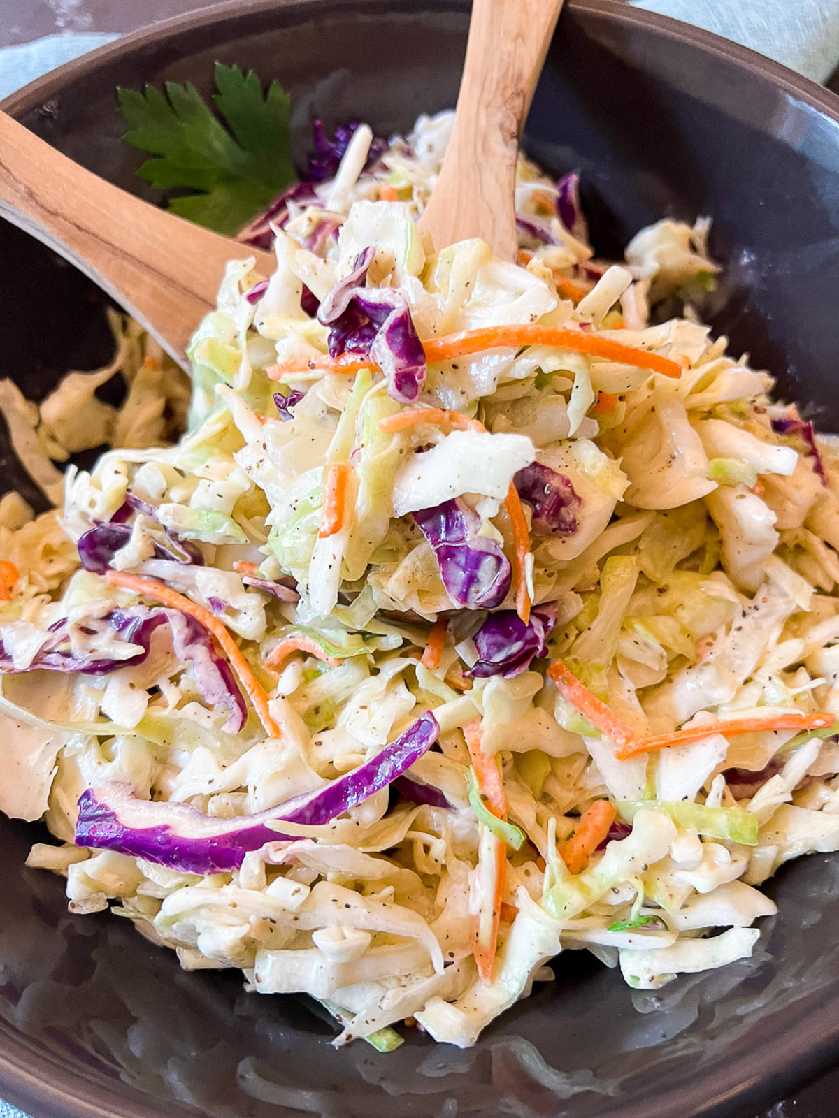 Coleslaw in a black bowl ready to eat.
