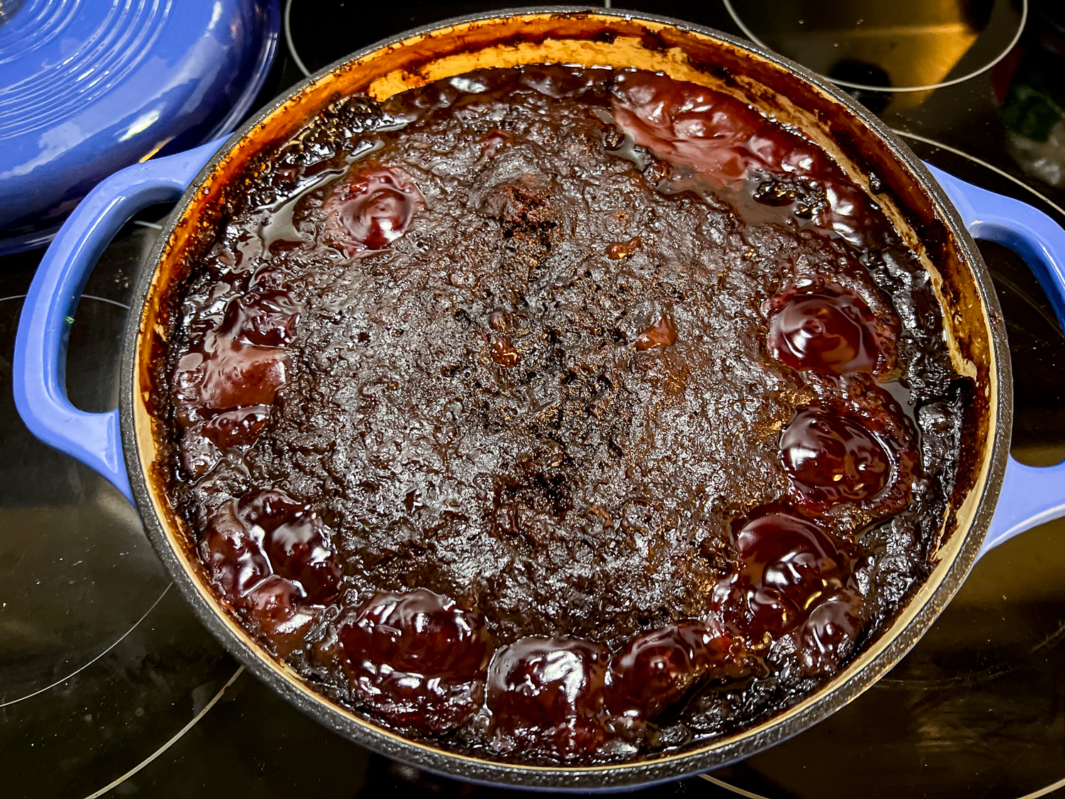 Fresh from the oven, the Cola Chocolate Cherry dump cake has bubbling fruit on the surface and a softly crusted cake topping.