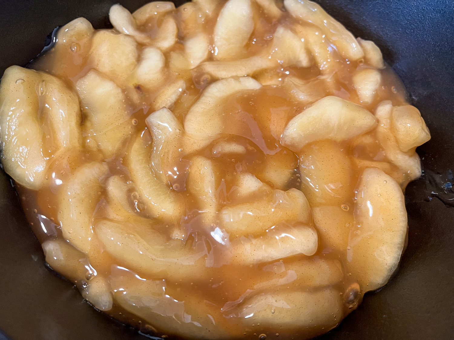 Apple pie filling added to the bottom of the skillet