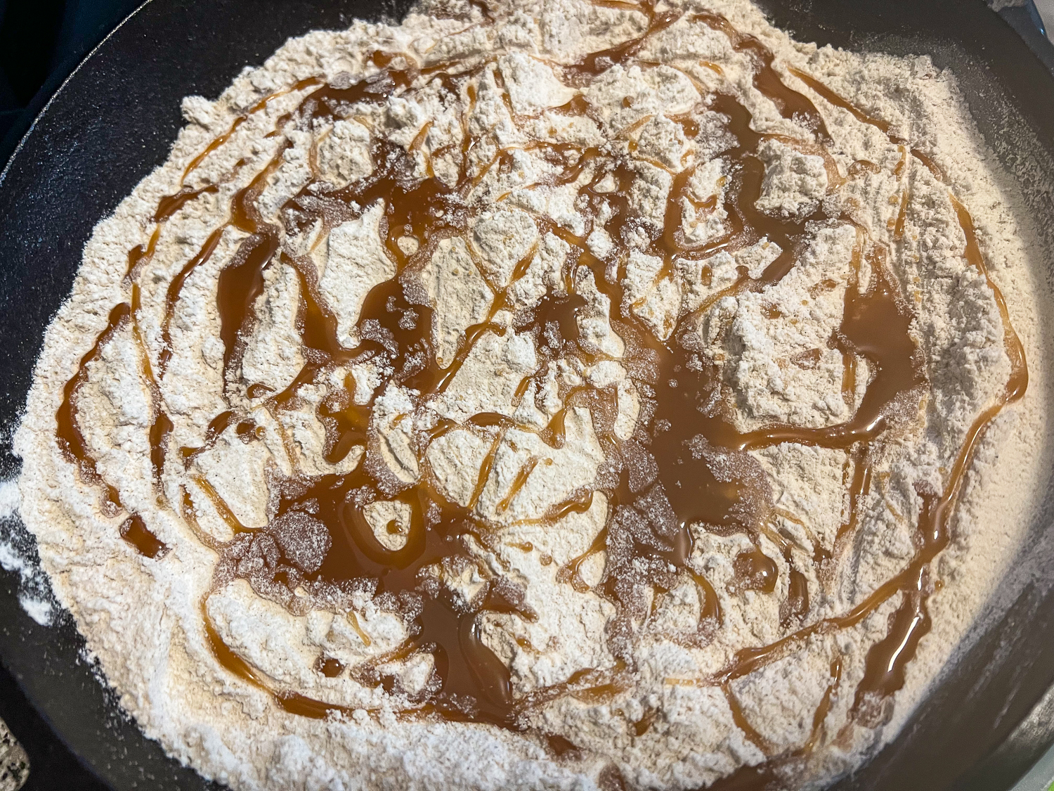 Caramel sauce drizzled over the powedered cake mix.