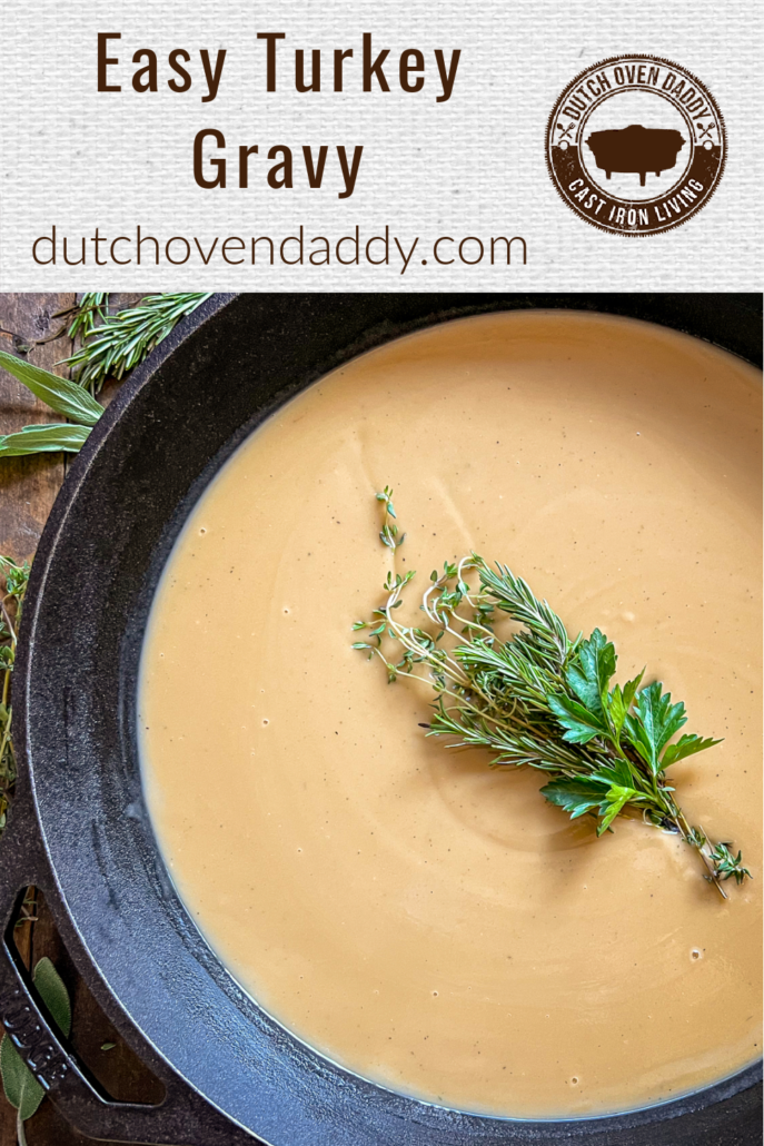 Branded Image of Turkey Gravy in a cast iron skillet with a boquest of herbs as a garnish.