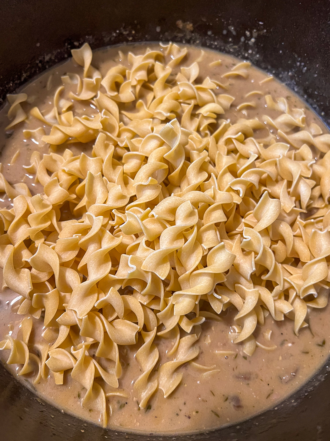 Dry egg noodles added to the beef, vegetables, and broth.