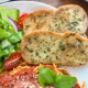 Two toasted slices of garlic bread close up.