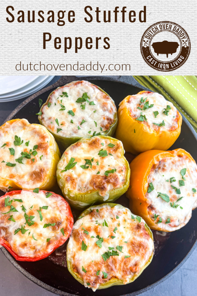 Branded image of a skillet full of cheese topped sausage stuffed peppers.