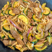 The teriyaki beef udon noodle stir fry is done and ready to be served from the cast iron wok.