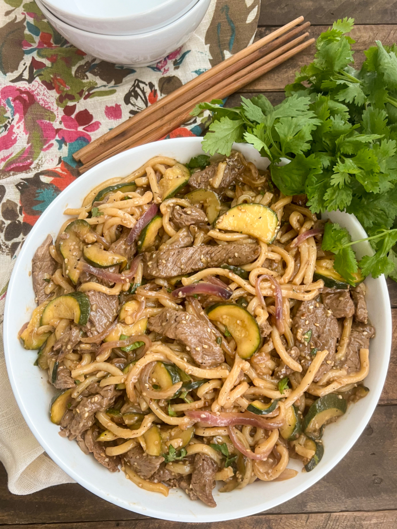 Plated in a white bowl, the teriyaki stir fry is read to eat.