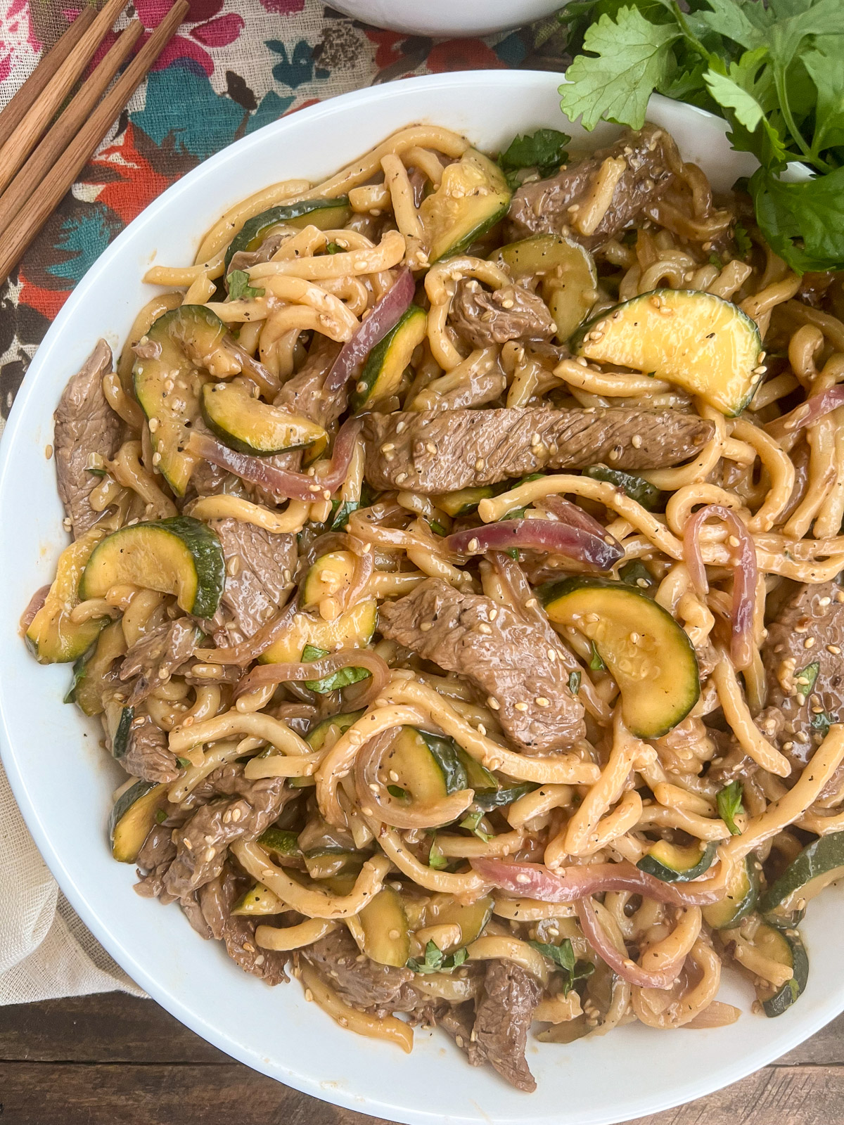 Plated in a white bowl, the teriyaki stir fry is read to eat.