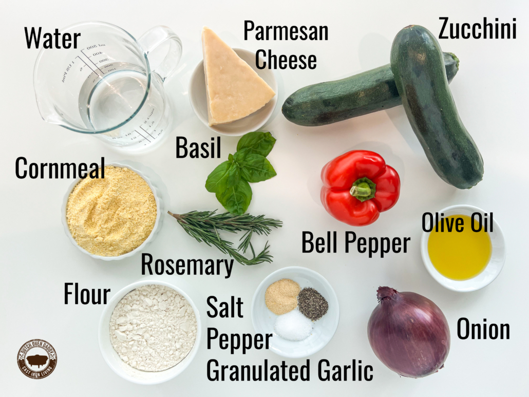 Ingredient array: water, parmesan cheese, zucchini, olive oil, bell pepper, rosemary, basil, cornmeal, flour, salt, pepper, granulated garlic, and onion.