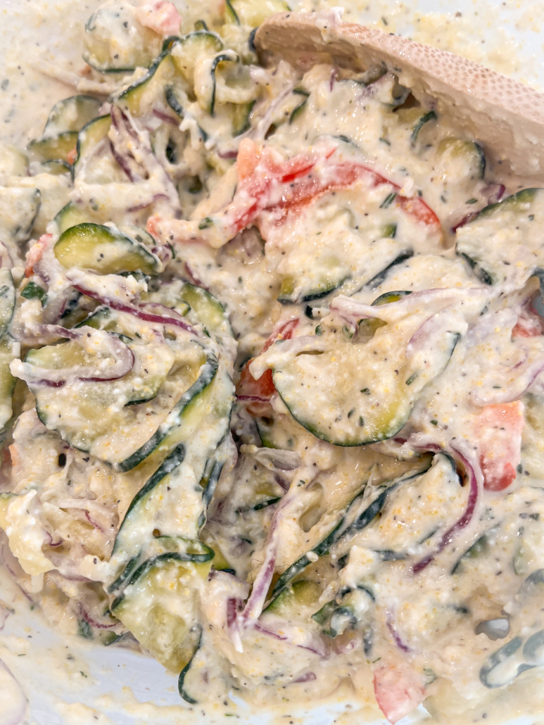 Zucchini, red onion, and red bell pepper has been stirred into the batter.