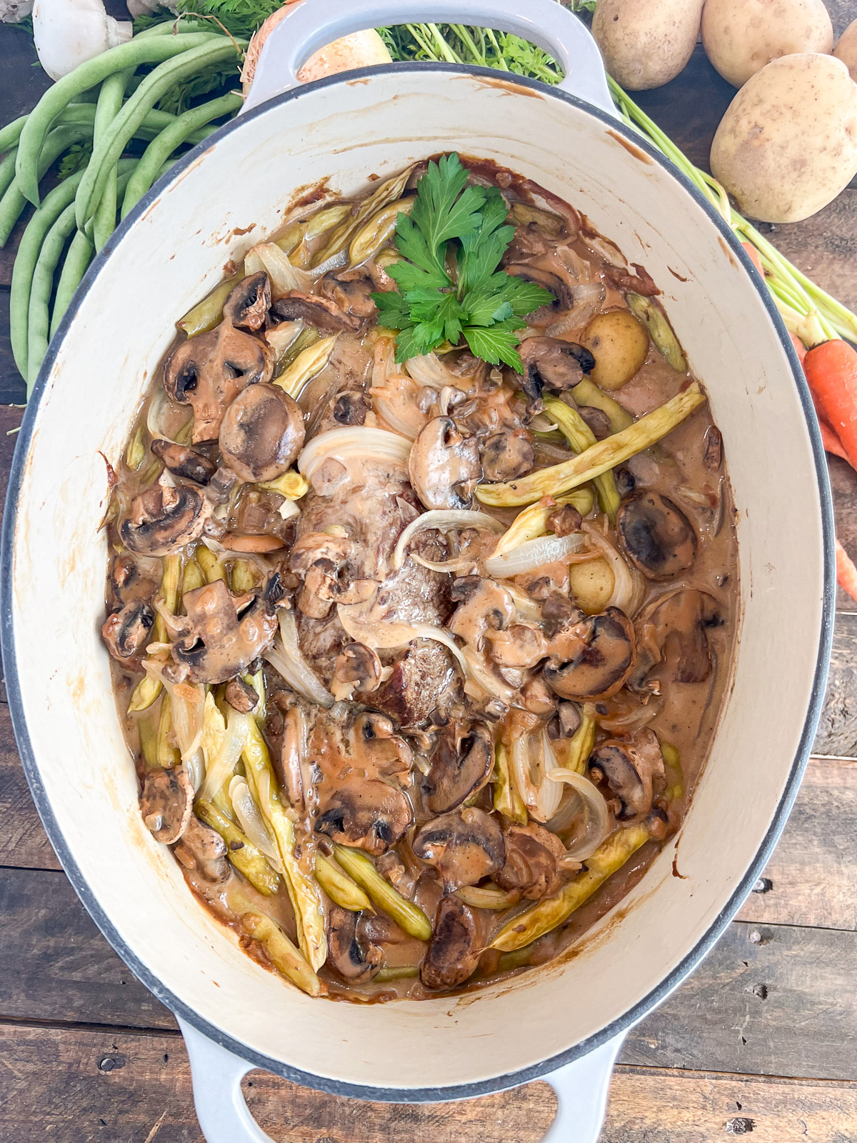 Image of pot roast with whiskey gravy in an oval dutch oven.