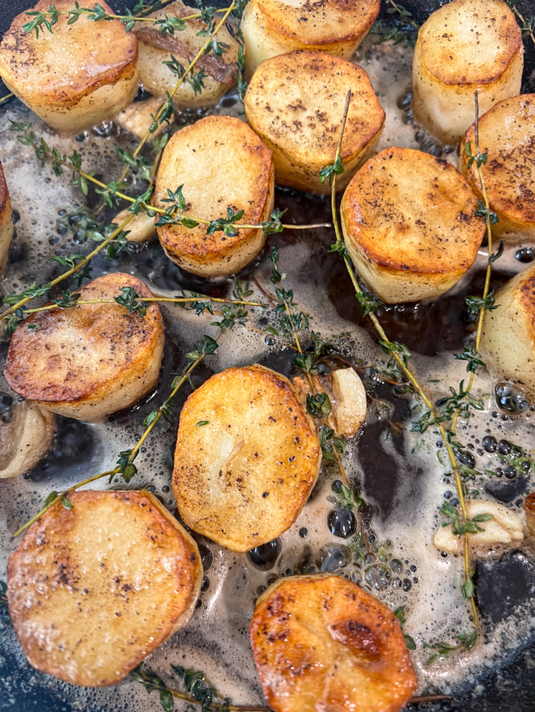 Fresh thyme and garlic has been added to the skillet.