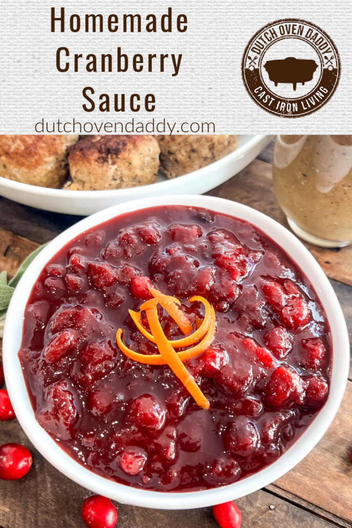 Homemade cranberry sauce garnished with fresh orange zest in a white bowl.